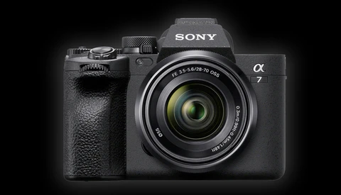 Sony Alpha 7 mirrorless camera with attached zoom lens against dark background.