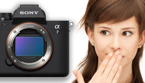 Sony a7 mirrorless camera body displayed next to a surprised woman's face.