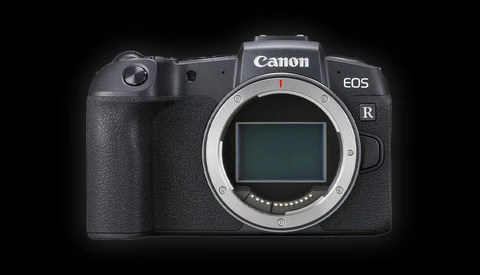 Canon EOS R mirrorless camera body with lens mount exposed against black background.