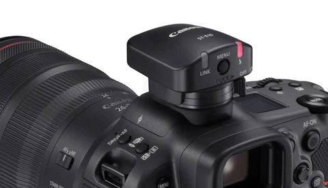 Canon mirrorless camera with RF lens and wireless flash transmitter mounted on top.