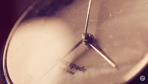 Close-up of a drum with drumstick mid-strike, shallow depth of field with warm vintage color grading.