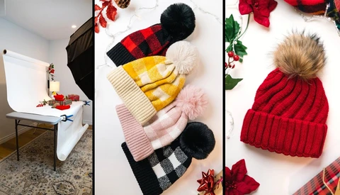 Product photography setup showing winter beanies with pom-poms and holiday decorations arranged on white surface.