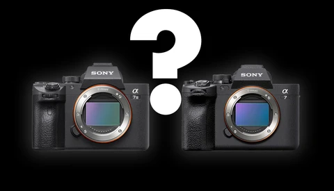 Comparison graphic of two Sony Alpha mirrorless camera bodies with a large question mark between them.