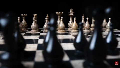 Chess pieces arranged on a board with selective focus and shallow depth of field.
