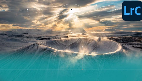 Snow-covered volcanic crater with turquoise geothermal water and dramatic crepuscular rays breaking through storm clouds.