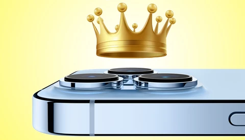 Illustration of a smartphone camera module with a golden crown floating above it against a yellow and blue background.