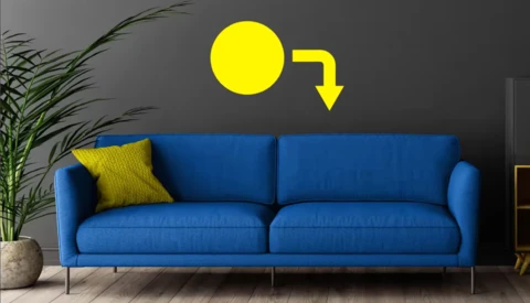 Interior design mockup showing a blue sofa with yellow accent pillow and directional arrow graphic above.