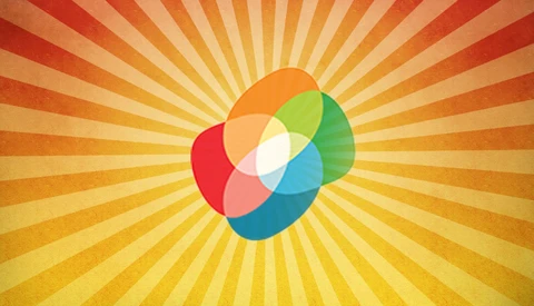 Illustration of overlapping colored circles arranged in a pinwheel pattern with a white center, radiating against a sunburst background.