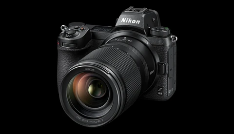 Nikon Z mirrorless camera with attached zoom lens, displayed against black background.