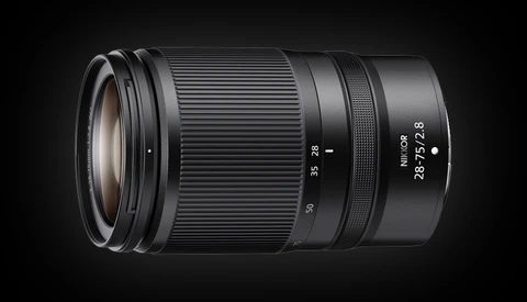 Nikon Z-mount telephoto zoom lens with 28-75mm focal length and f/2.8 maximum aperture against dark background.