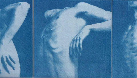 Cyanotype triptych of a female figure in three poses with arms raised and hand placements.
