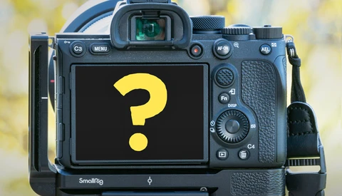 Professional mirrorless camera with SmallRig cage displaying a yellow question mark on its LCD screen.