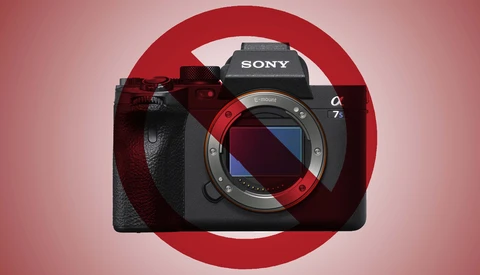 Sony a7 mirrorless camera body with red accent ring displayed against pink background.