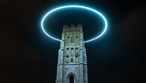 Stone tower on a grassy hill illuminated by a bright cyan neon ring hovering above it against a dark night sky.