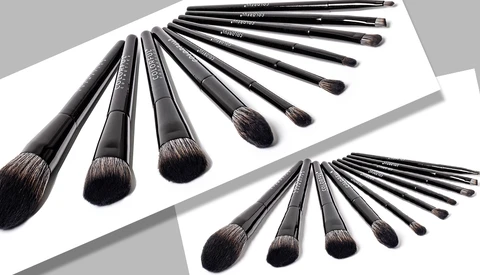 Two sets of professional makeup brushes arranged in curved rows against white paper.