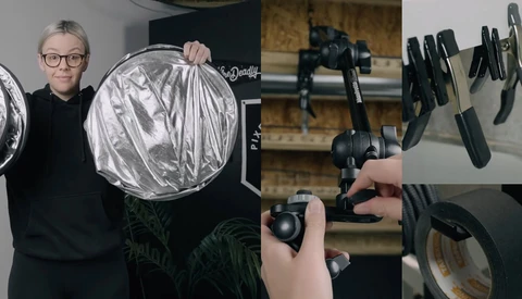 Photographer holding circular silver reflector with various lighting modifiers displayed on right side.