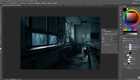Dark, moody interior room with large windows showing blue-tinted outdoor light and industrial architectural elements.