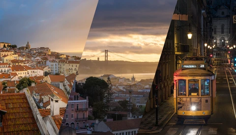 Yellow tram on tracks with Lisbon cityscape and bridge at sunset.
