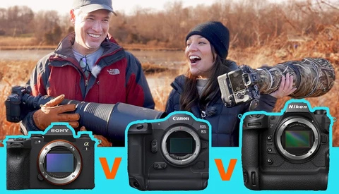 Two photographers outdoors holding telephoto lenses with three camera bodies displayed below them.