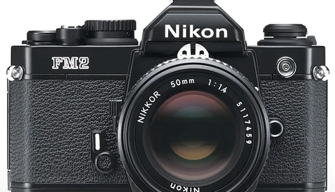Nikon FM2 35mm film camera with Nikkor 50mm f/1.4 lens, front view on white background.
