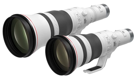 Two white telephoto lenses with black barrels and front elements arranged side by side.
