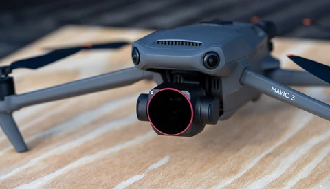 DJI Mavic 3 drone with gimbal and camera system mounted, displayed on wooden surface.