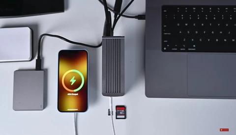 Smartphone displaying a charging animation with a lightning bolt icon on a bright yellow-orange screen.