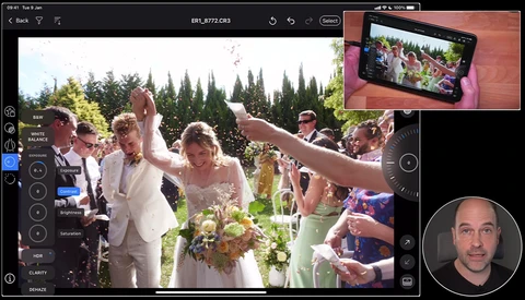 Wedding ceremony with bride and groom raising hands as guests celebrate outdoors under evergreen trees.