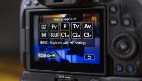 Screenshot of a camera's manual exposure mode menu displaying exposure compensation options and custom function settings.
