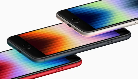 Three smartphones arranged in a cascading composition, each displaying a colorful gradient spectrum across its screen.