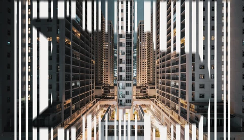 Urban canyon view through geometric white vertical lines, dense apartment buildings converging toward distant courtyard.