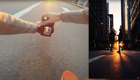 Two hands exchanging a small decorative object on an asphalt surface during golden hour.