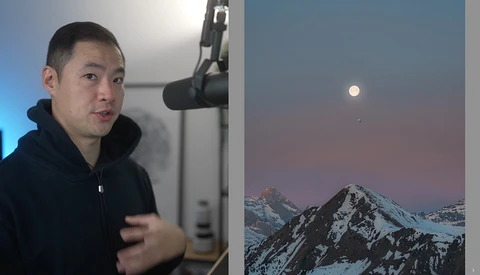 Photographer speaking beside a studio microphone, gesturing while displaying a snow-capped mountain landscape on a monitor.