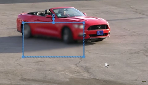 Red convertible Mustang with selection box overlay demonstrating photo editing or masking technique.