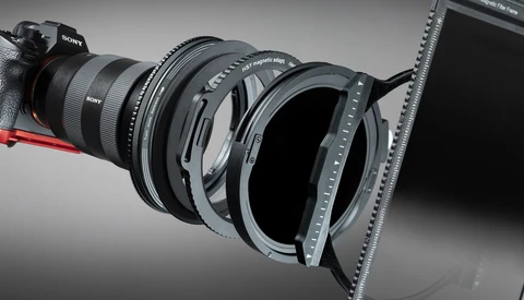 Sony camera lens with matte box and filter holder attachment system displayed in studio lighting.