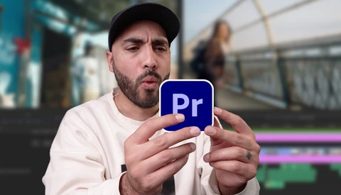 Man holding Adobe Premiere Pro logo icon with editing interface visible in background.