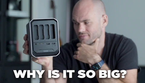 Man holding a compact desktop computer tower while questioning its size.