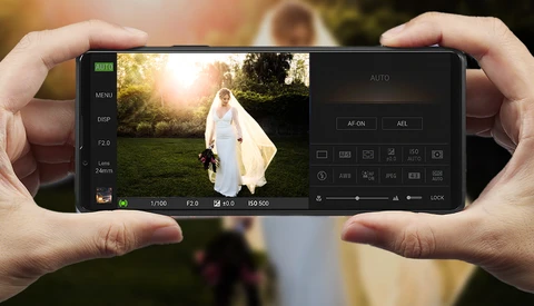 Screenshot of a smartphone camera app displaying a bride in a white gown outdoors with golden hour lighting.