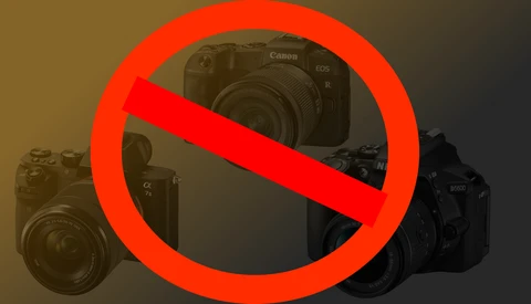 Illustration of three professional cameras with a red prohibition symbol overlaid across them.