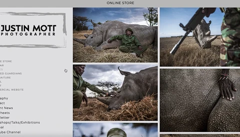 Wildlife photographer documenting close-up details of a rhinoceros in natural habitat.