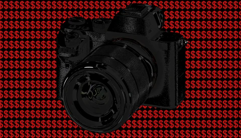 Professional camera with large telephoto lens centered against red dollar sign pattern background.
