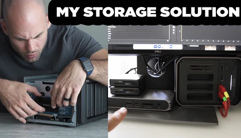 Person installing hard drives into a multi-bay storage enclosure with cables and equipment visible.