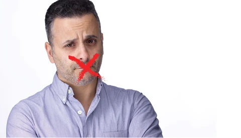 Man with red X marked across his mouth against white background.