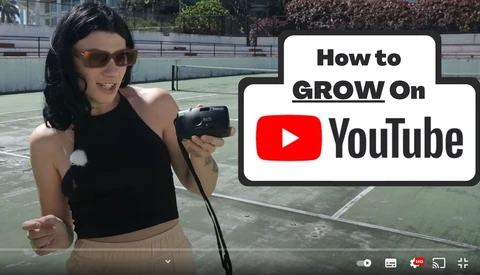 Content creator holding a camera on an outdoor tennis court during daytime with YouTube branding and text overlay about growing on the platform.