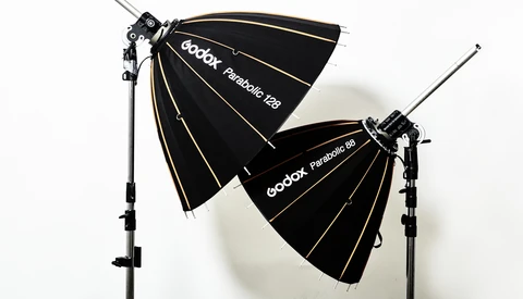 Two Godox Parabolic softboxes mounted on light stands against a white background.