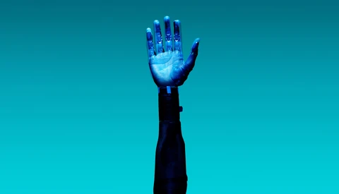 Illuminated hand raised against solid turquoise background with glowing blue light effect.