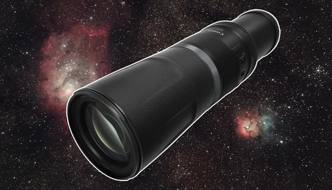 Telephoto lens positioned against a starfield with nebulae and cosmic dust clouds.