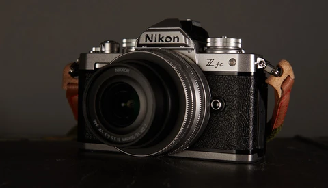 Nikon Zfc mirrorless camera with wood grip accessories, mounted with a standard lens.