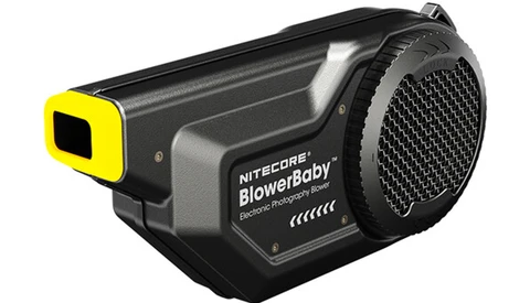 Nitecore BlowerBaby electronic photography blower with yellow accents and mesh grille.