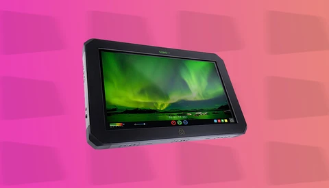 Professional on-camera monitor displaying aurora borealis footage with control interface visible.